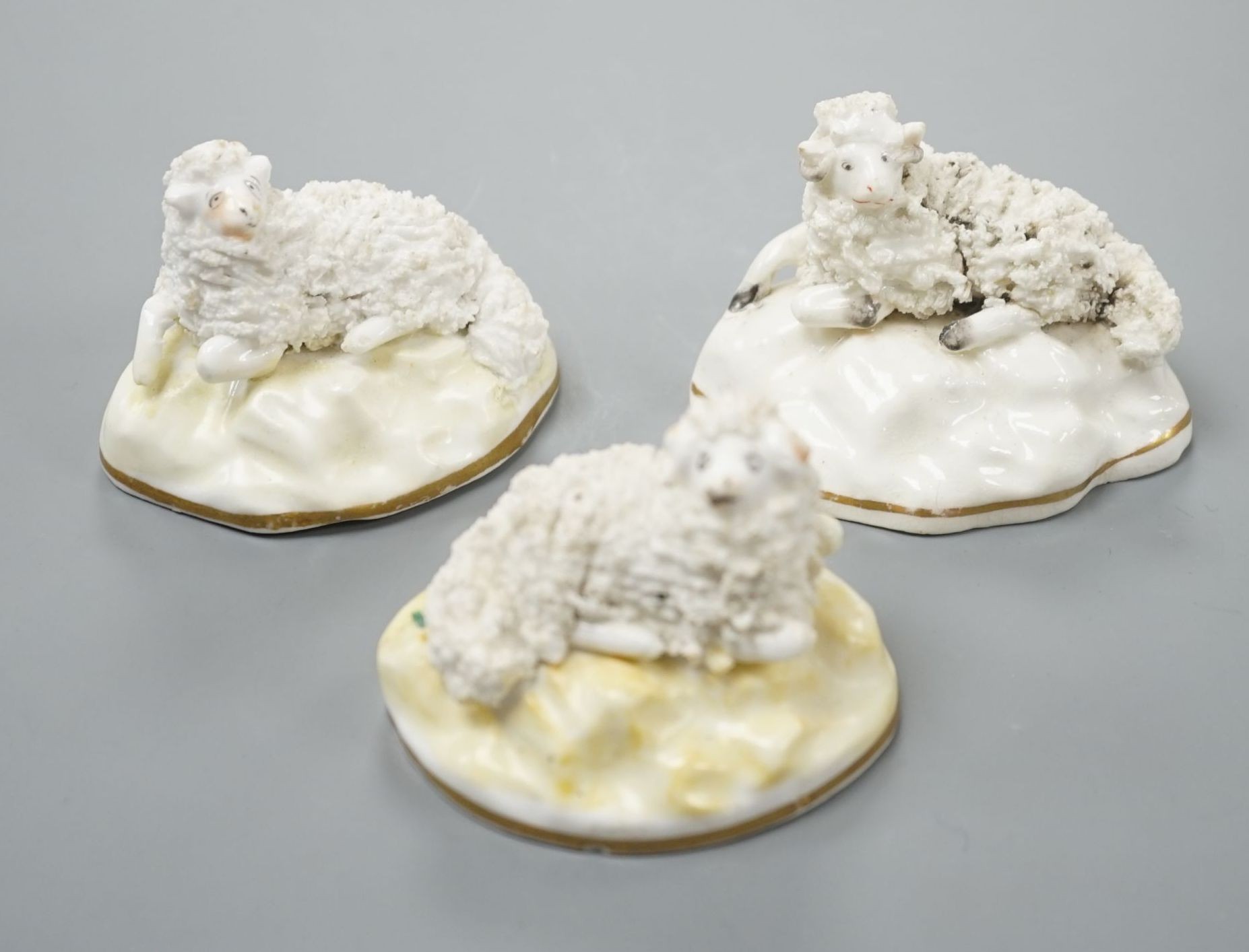 A pair of Samuel Alcock porcelain models of a ram and a ewe, d.1835–50, impressed mark ‘86’, largest 6.6 cm long together with a similar Staffordshire porcelain model of a ram (3), Provenance: Dennis G.Rice collection
